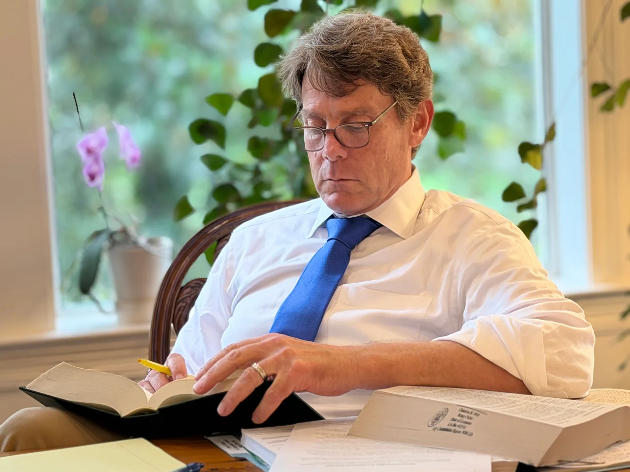 Cameron Mary doing research for a case looking at a law book for answers