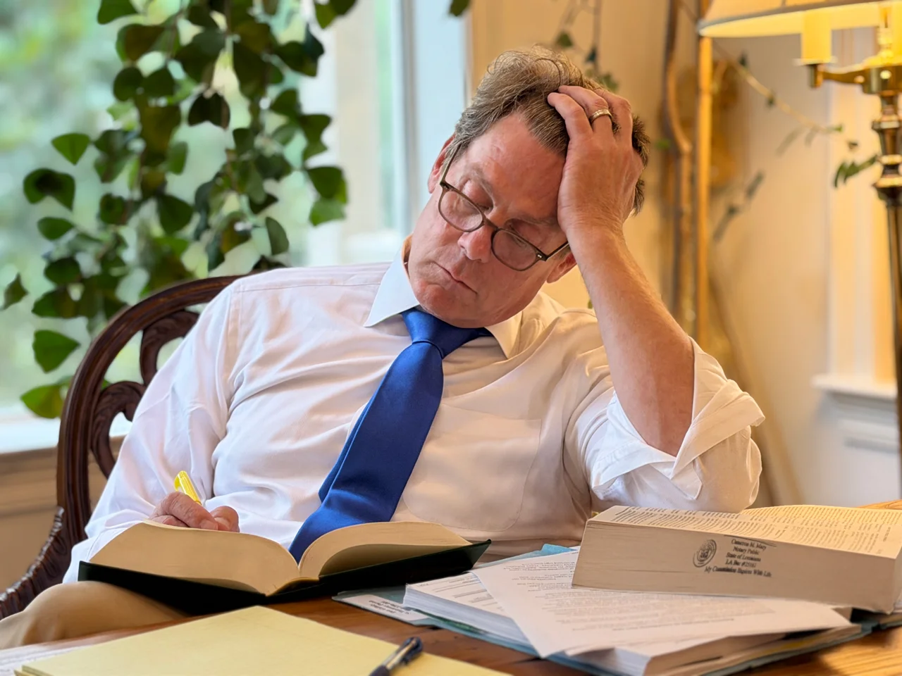 Cameron Reading a Law book while doing research on a case.